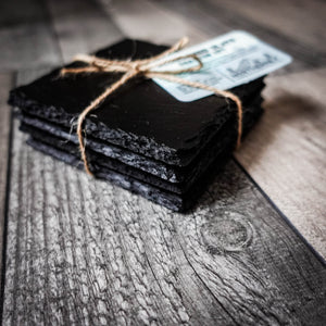 Handcrafted set of 4 blackened riven slate coasters tied with jute twine.