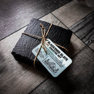 Handcrafted set of 4 blackened riven slate coasters tied with jute twine.