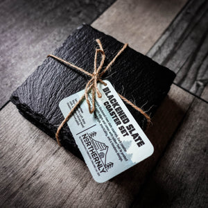 Handcrafted set of 4 blackened riven slate coasters tied with jute twine.